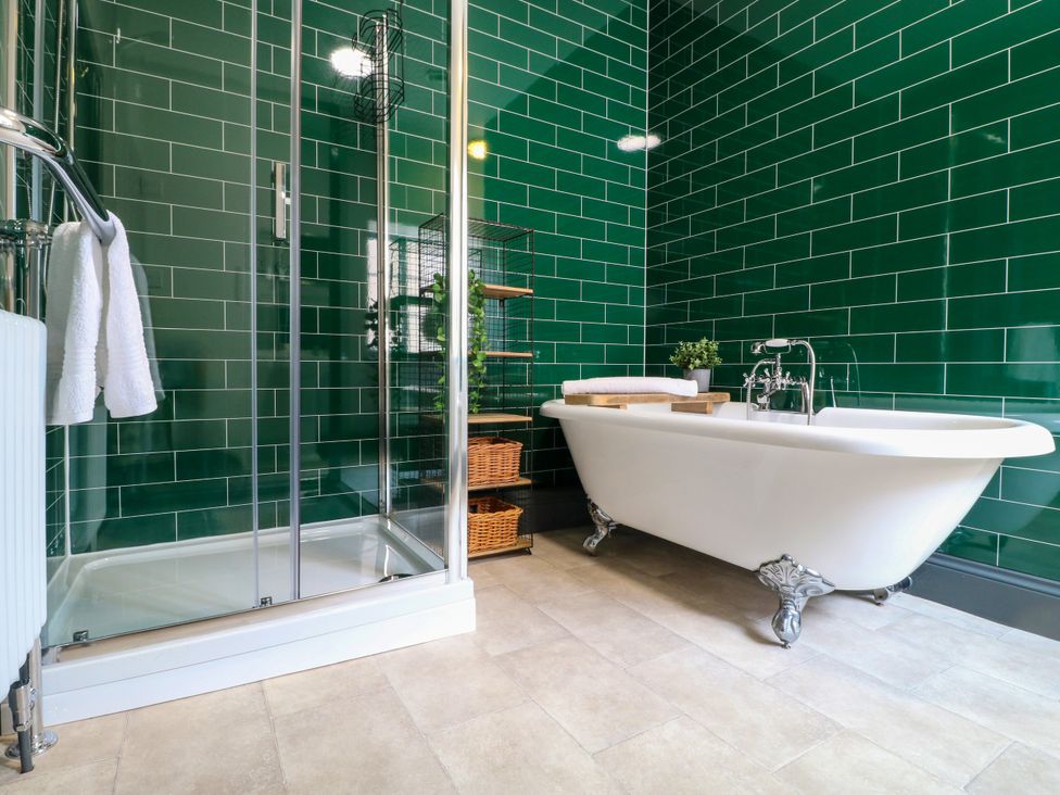 A bathroom featuring a bathtub and shower at Haarlem House Wirksworth