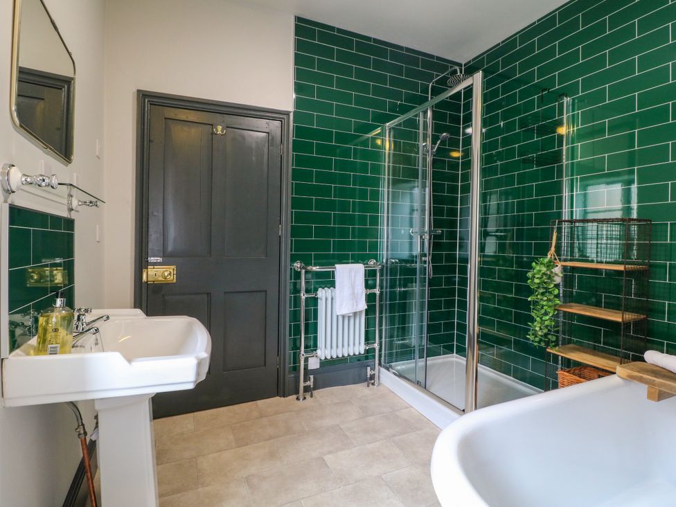 A bathroom with a shower, sink, and bathtub at Haarlem House in Wirksworth