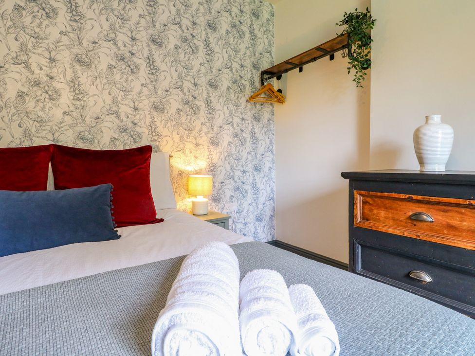 A bedroom with a bed and pillows at Haarlem House in Wirksworth
