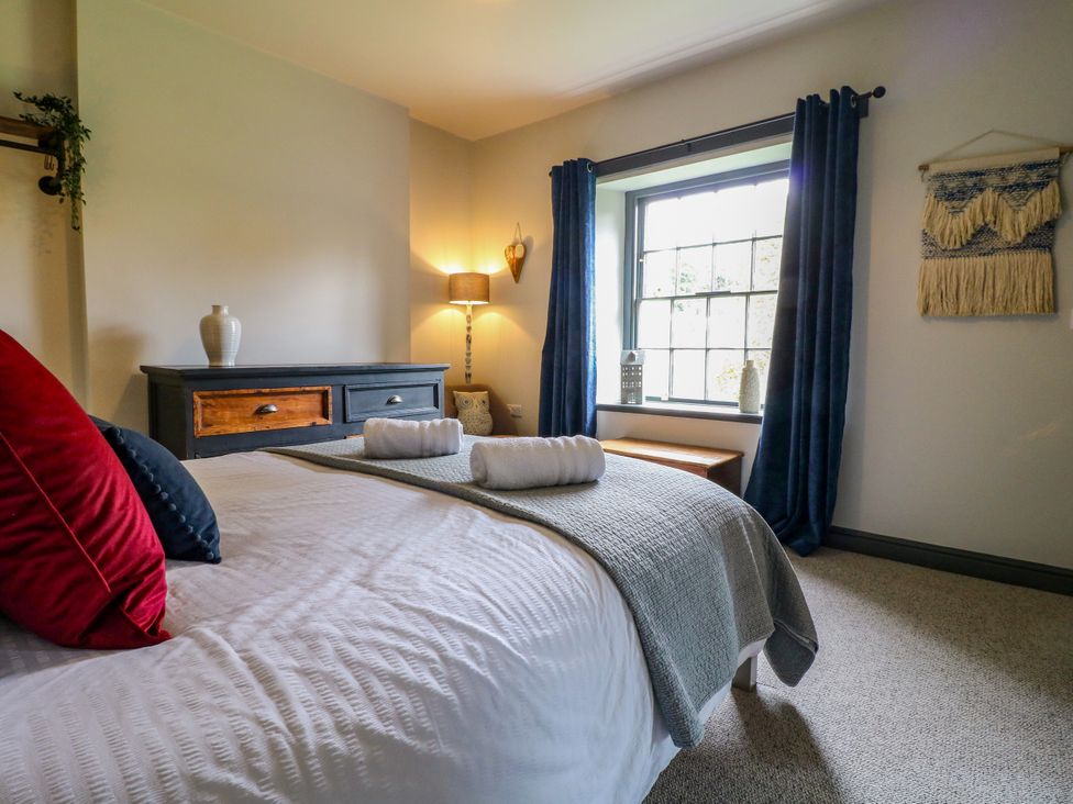 A bedroom with a bed and dresser at Haarlem House in Wirksworth