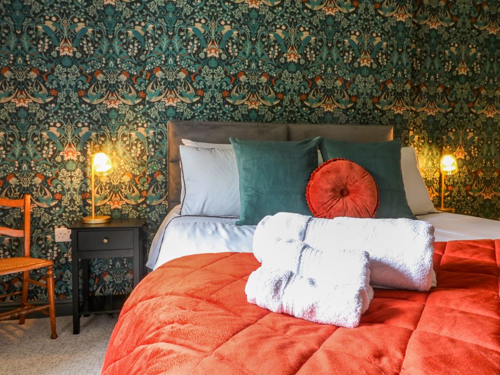 A bedroom with a bed and towels at Haarlem House in Wirksworth