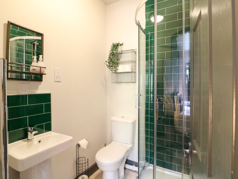 A bathroom with a toilet, sink and shower at Haarlem House in Wirksworth
