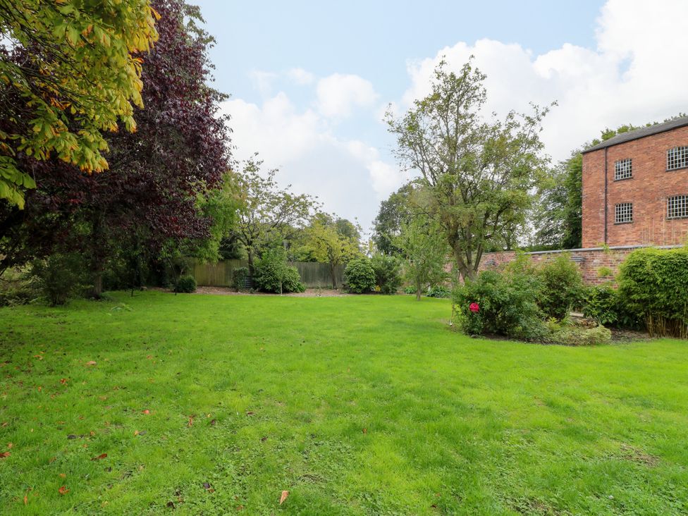 A garden with trees and a lawn at Haarlem House in Wirksworth