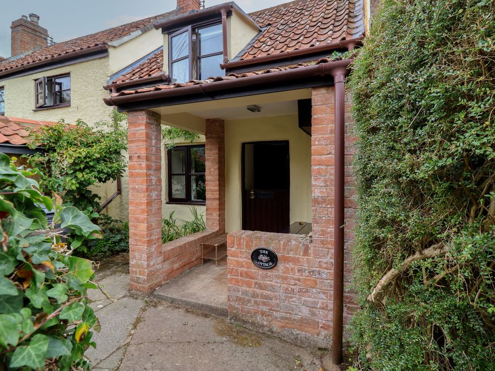 An entryway with brick wall and door at The Cottage in Bridgwater