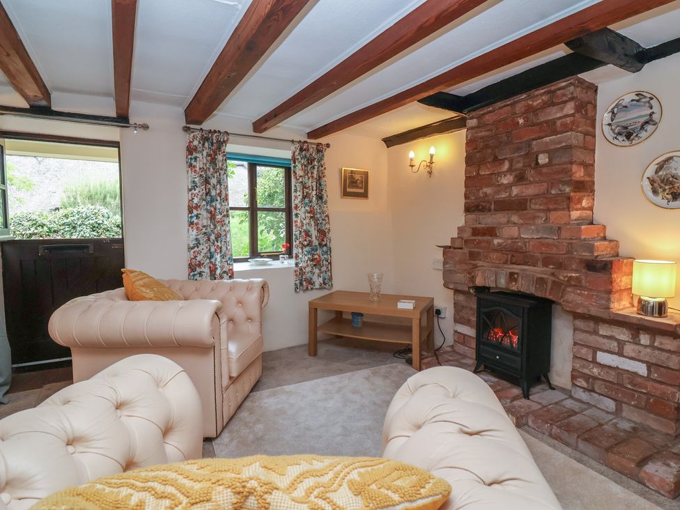 A living room with a sofa and a fireplace at The Cottage in Bridgwater