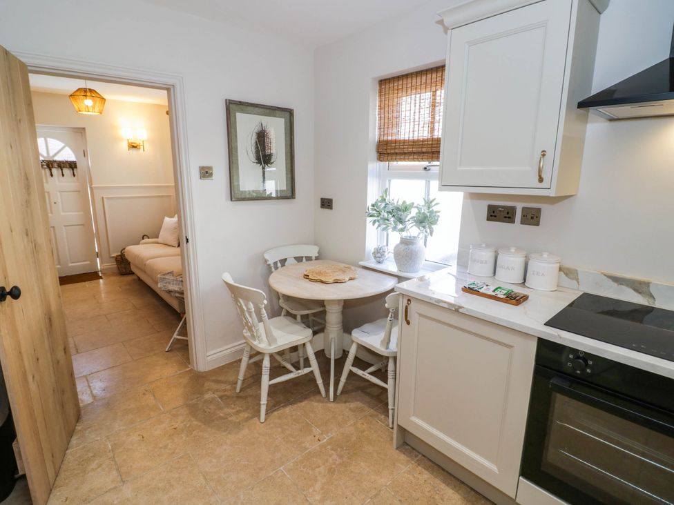 A kitchen with a table and chairs at Albert Cottage Stratford-upon-Avon