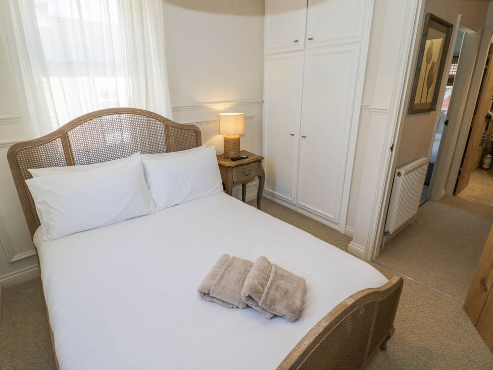 A bedroom with a bed and bedside table at Albert Cottage in Stratford-upon-Avon