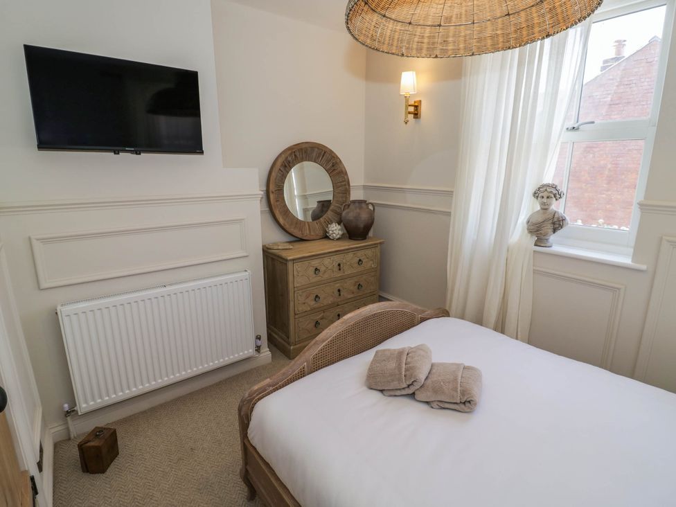 A bedroom with a bed and television at Albert Cottage Stratford-upon-Avon