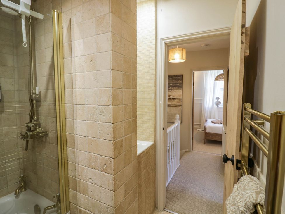 A bathroom with a shower and bathtub at Albert Cottage Stratford-upon-Avon