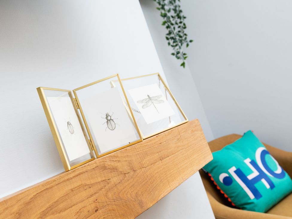 A shelf with framed artwork and a cushion at 38 Ashville Avenue, Scarborough