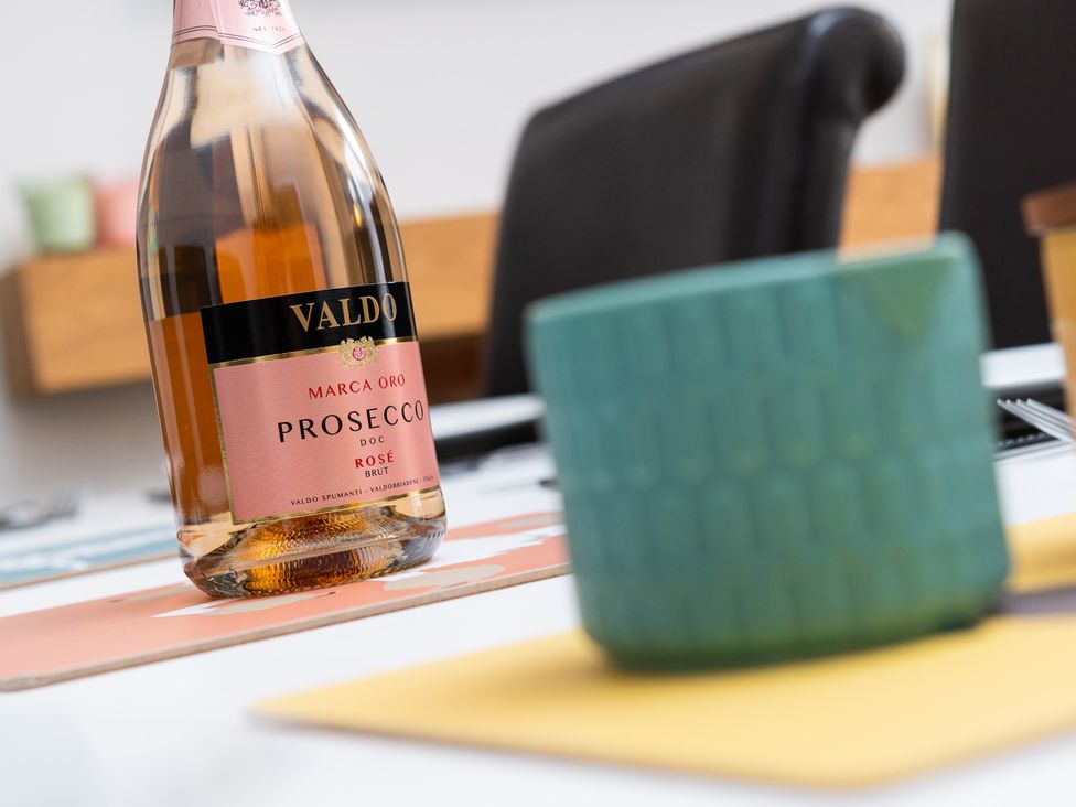 A Prosecco bottle and a green cup on a table at 38 Ashville Avenue in Scarborough