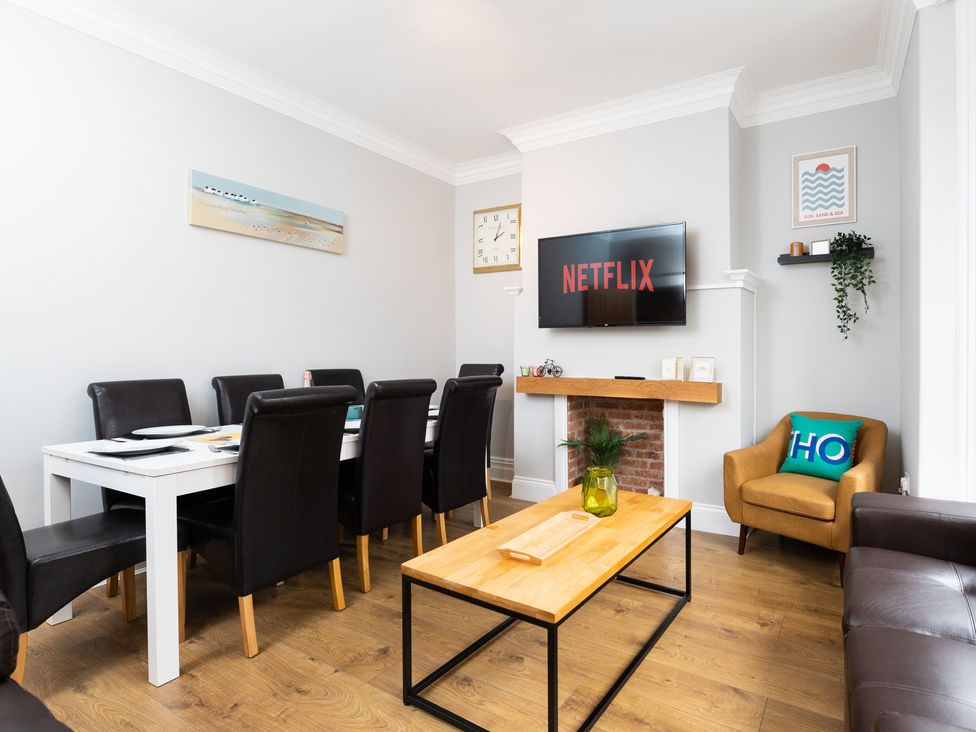 A dining room with a table and chairs, television and sofa at 38 Ashville Avenue in Scarborough