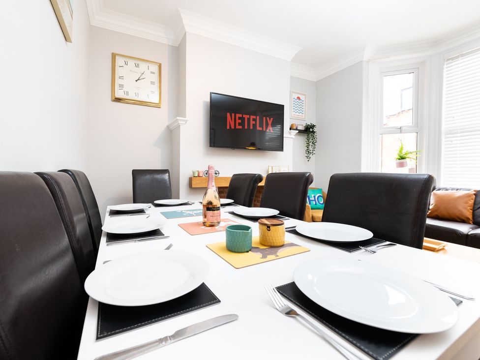 A dining room with a table set for meals at 38 Ashville Avenue in Scarborough