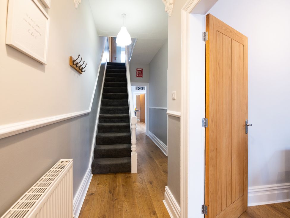 A hallway with a staircase and door at 38 Ashville Avenue Scarborough