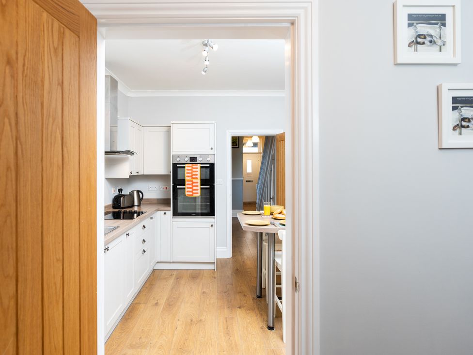 A kitchen with an oven and table at 38 Ashville Avenue in Scarborough
