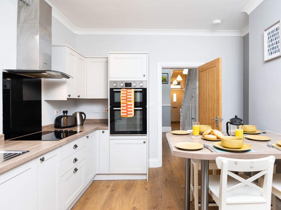 A kitchen with a table set for breakfast at 38 Ashville Avenue in Scarborough