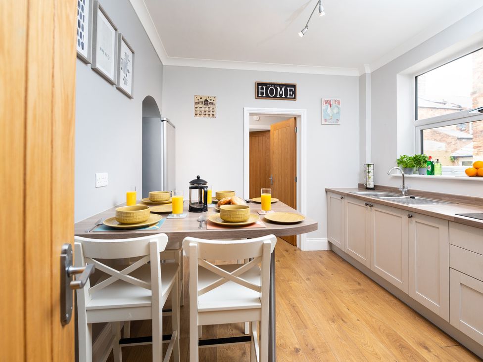 A kitchen with a dining table set and a door at 38 Ashville Avenue Scarborough