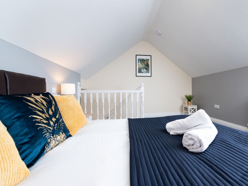 A bedroom with a bed and side table at 38 Ashville Avenue in Scarborough