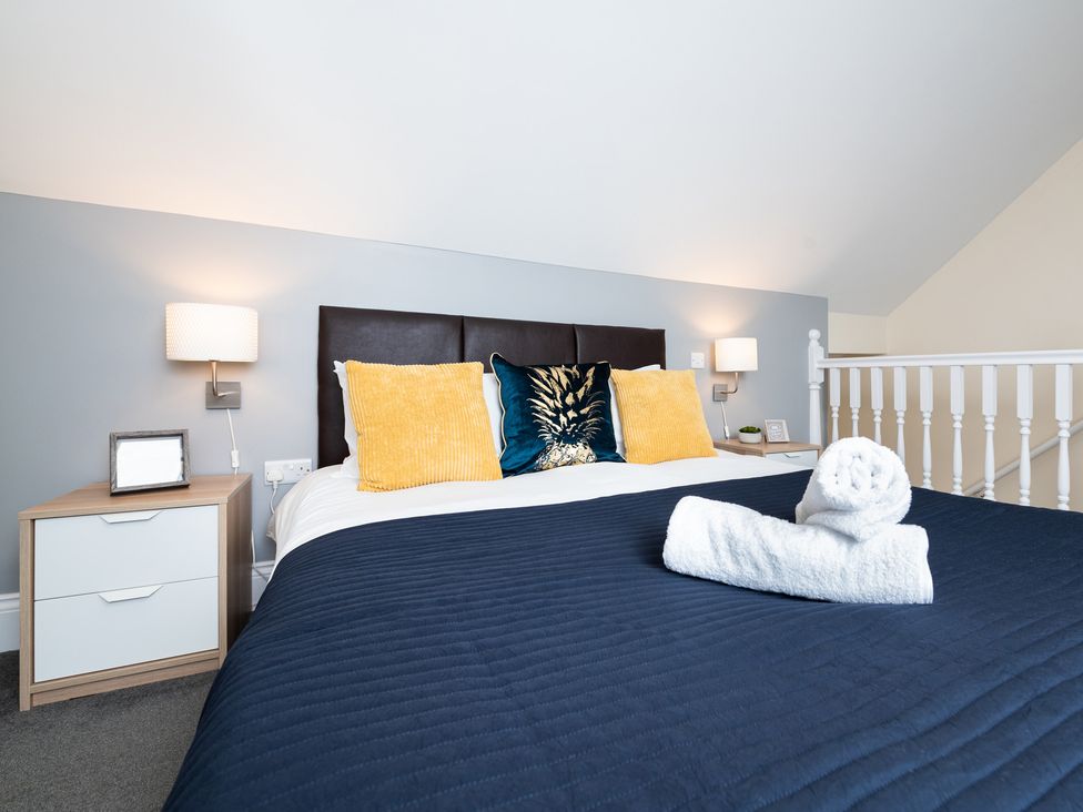 A bedroom with a bed and nightstand at 38 Ashville Avenue Scarborough