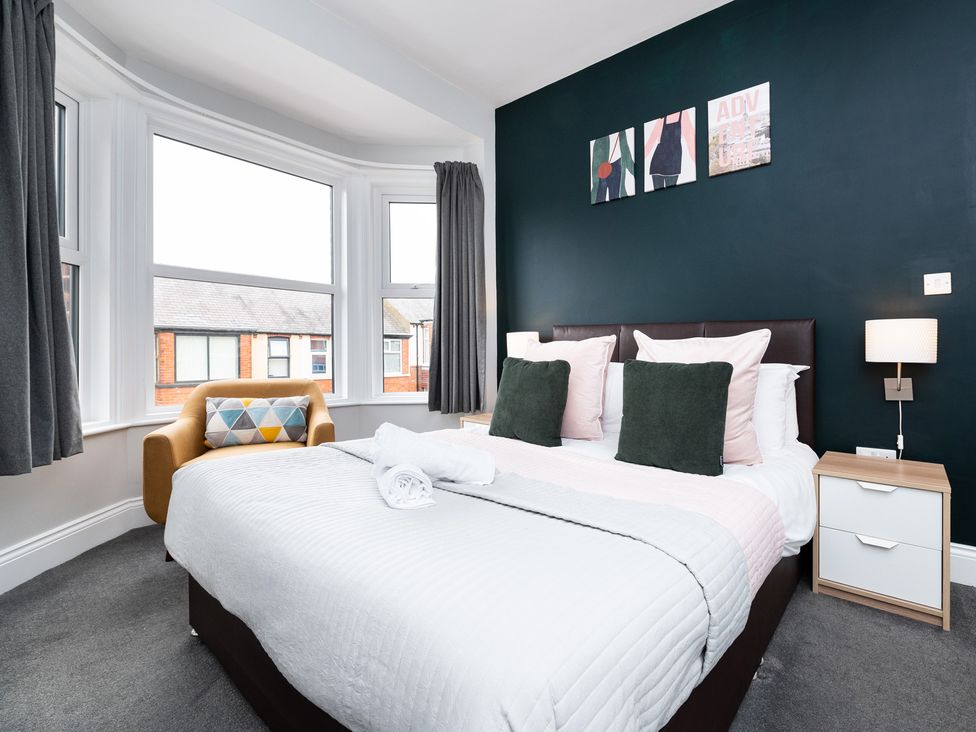A bedroom with a bed and armchair at 38 Ashville Avenue Scarborough