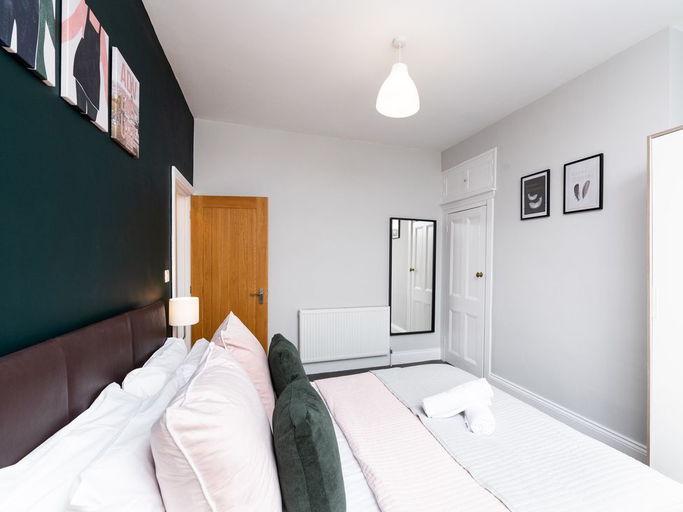 A bedroom with a bed and artworks on the wall at 38 Ashville Avenue, Scarborough
