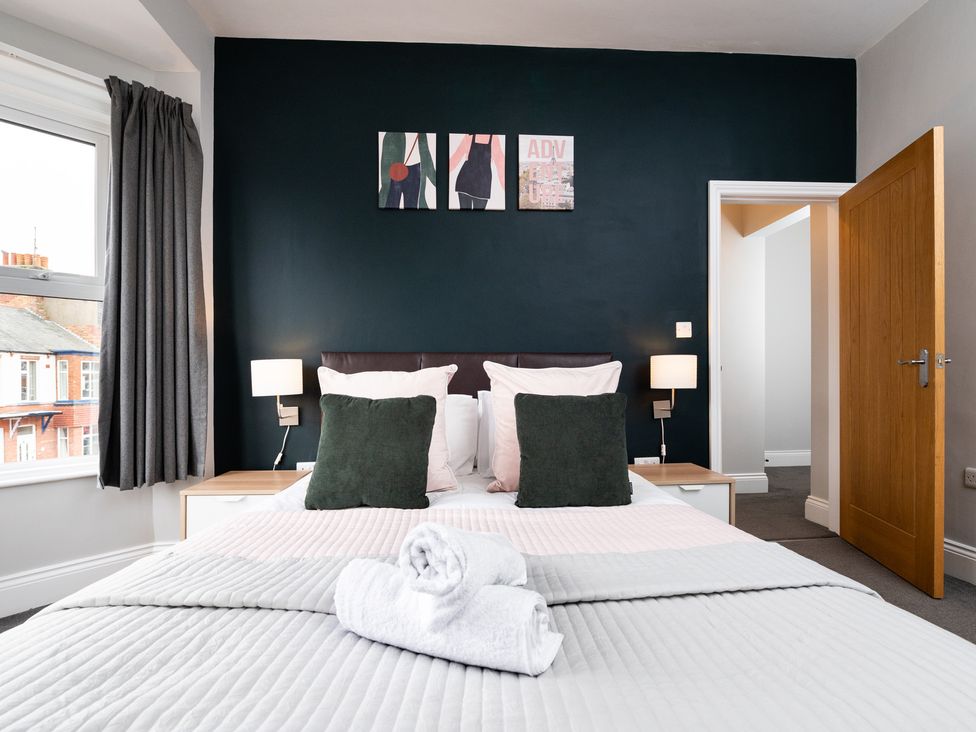 A bedroom with a bed and artwork at 38 Ashville Avenue Scarborough