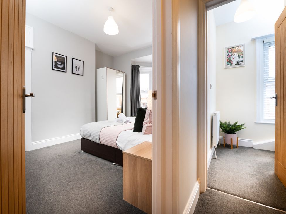A bedroom with a bed and wardrobe at 38 Ashville Avenue in Scarborough