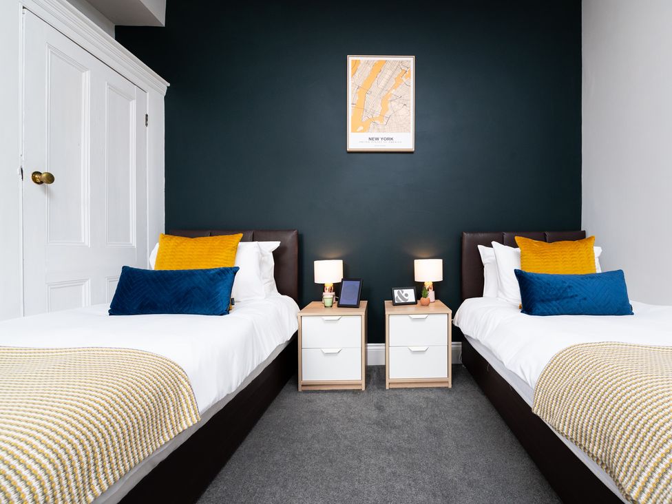 A bedroom with two single beds and nightstands at 38 Ashville Avenue Scarborough