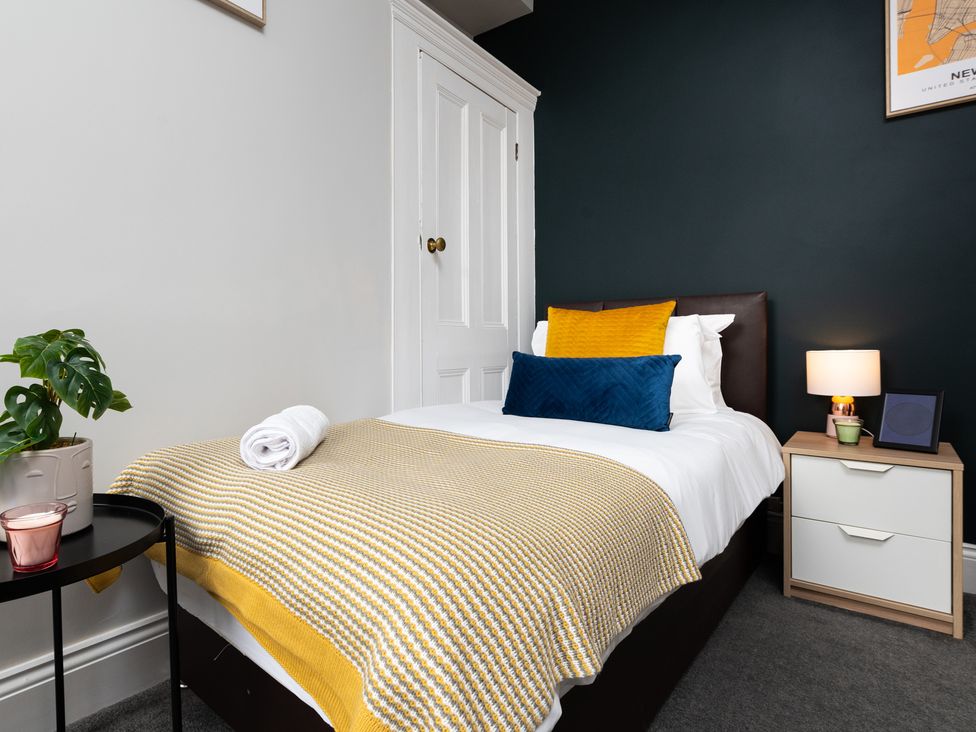 A bedroom with a bed and bedside table at 38 Ashville Avenue in Scarborough