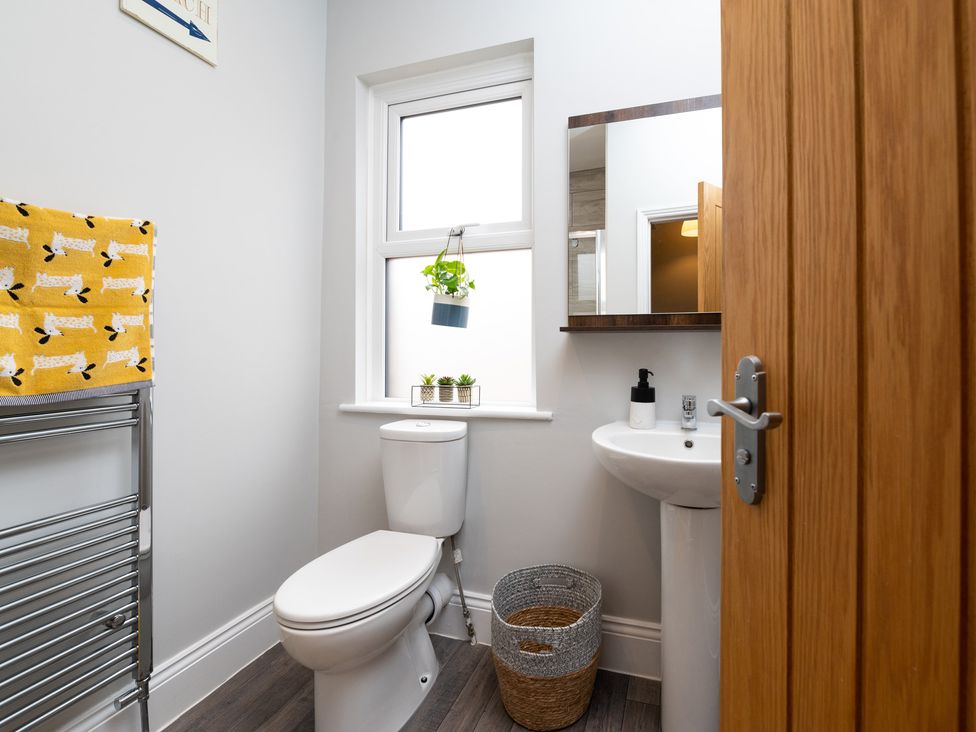 A bathroom with a toilet and sink at 38 Ashville Avenue, Scarborough
