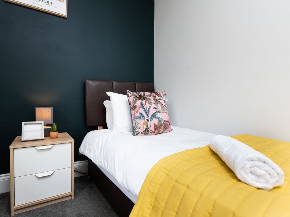 A bedroom with a bed and nightstand at 38 Ashville Avenue Scarborough