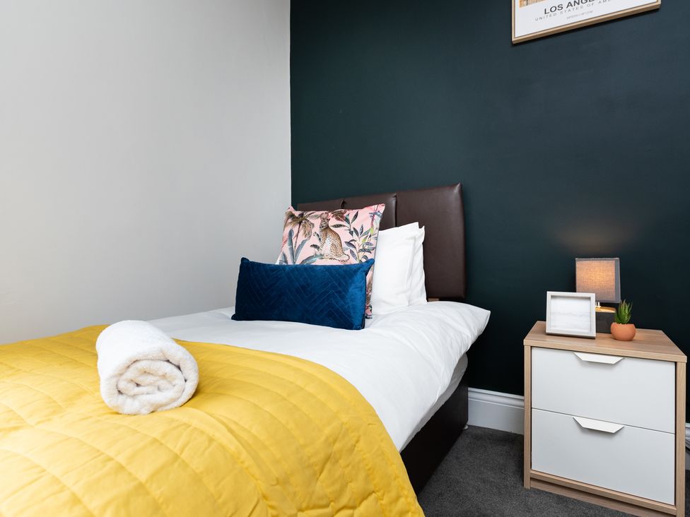 A bedroom with a bed and nightstand at 38 Ashville Avenue, Scarborough