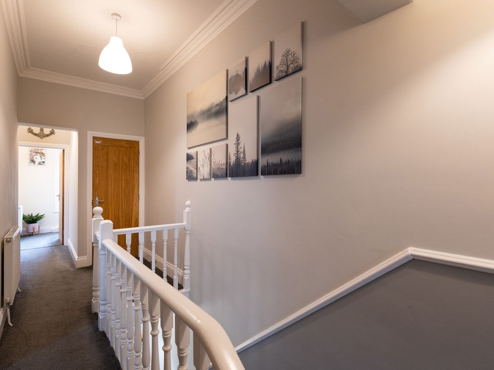 A hallway with pictures on the wall and a staircase at 38 Ashville Avenue, Scarborough
