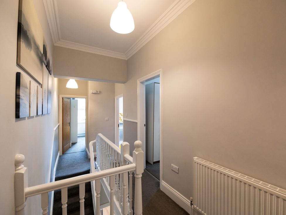 A hallway with stairs and doors at 38 Ashville Avenue Scarborough