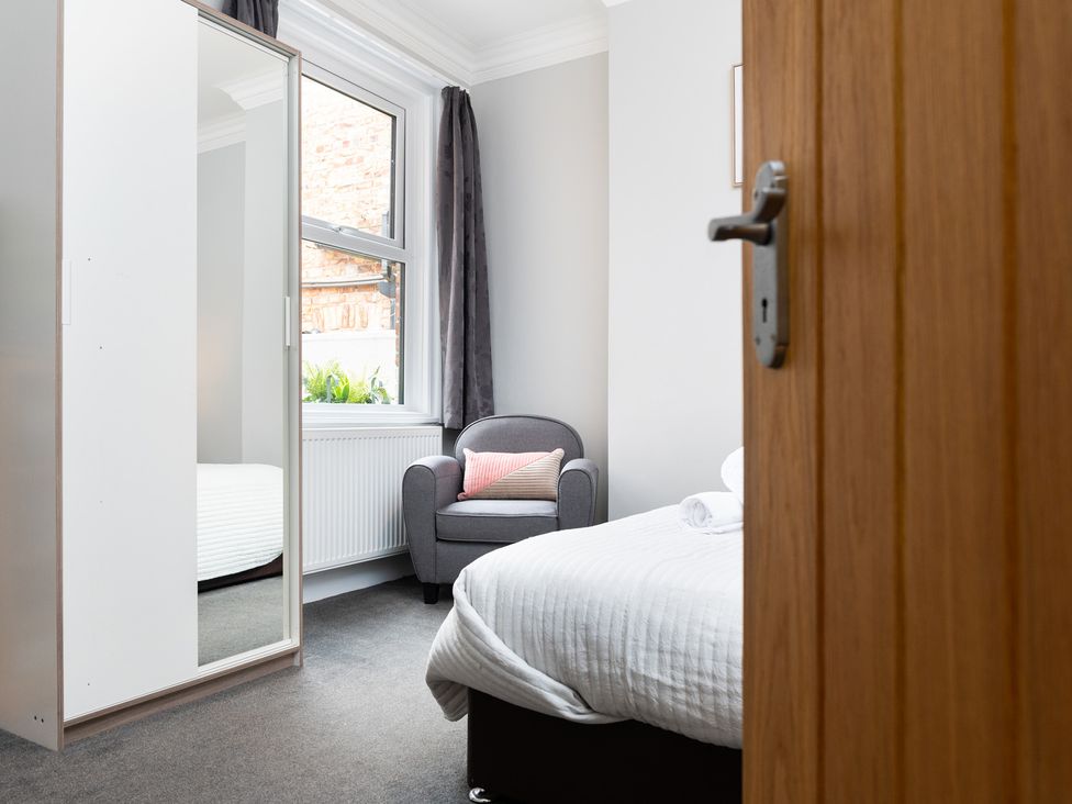 A bedroom with a bed and a chair at 38 Ashville Avenue Scarborough