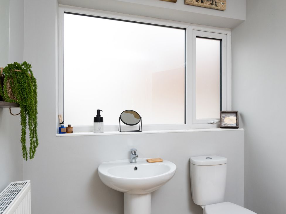 A bathroom with a sink and toilet at 38 Ashville Avenue Scarborough