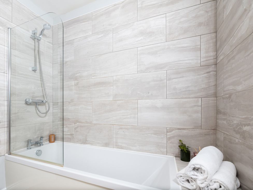 A bathroom featuring a bathtub and shower at 38 Ashville Avenue, Scarborough