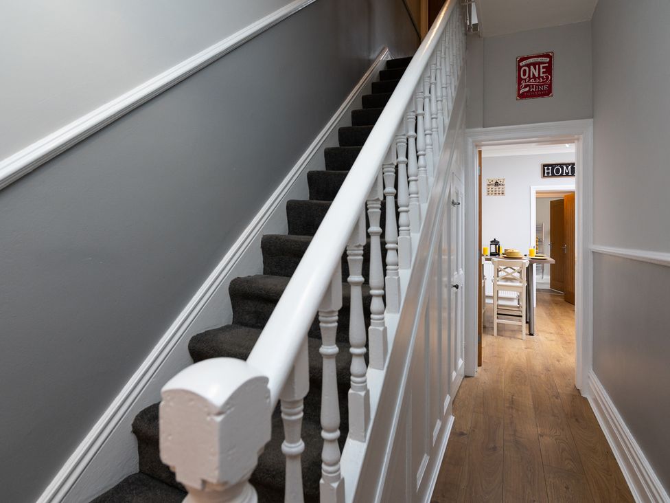 A hallway with a staircase leading up and a table in the background at 38 Ashville Avenue, Scarborough