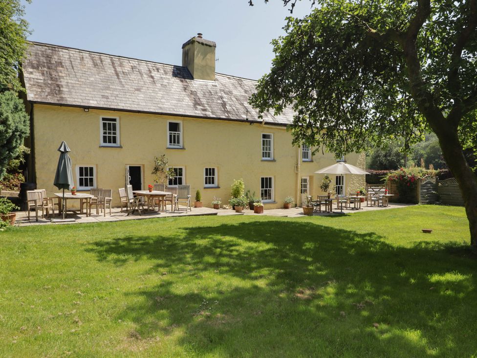 A house with tables and chairs in the garden at Ty Mawr Country House in Carmarthen