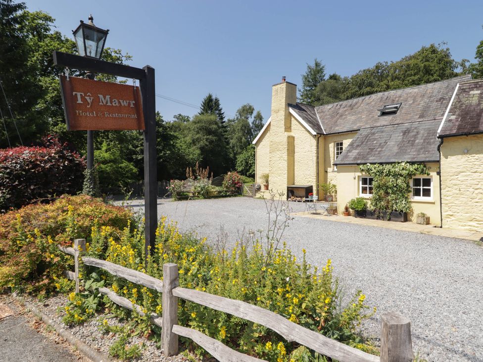 A hotel building with a sign at Ty Mawr Country House in Carmarthen