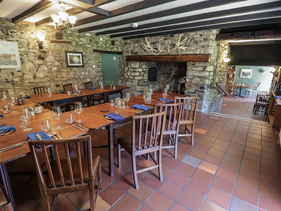 A dining room with tables and chairs at Ty Mawr Country House in Carmarthen
