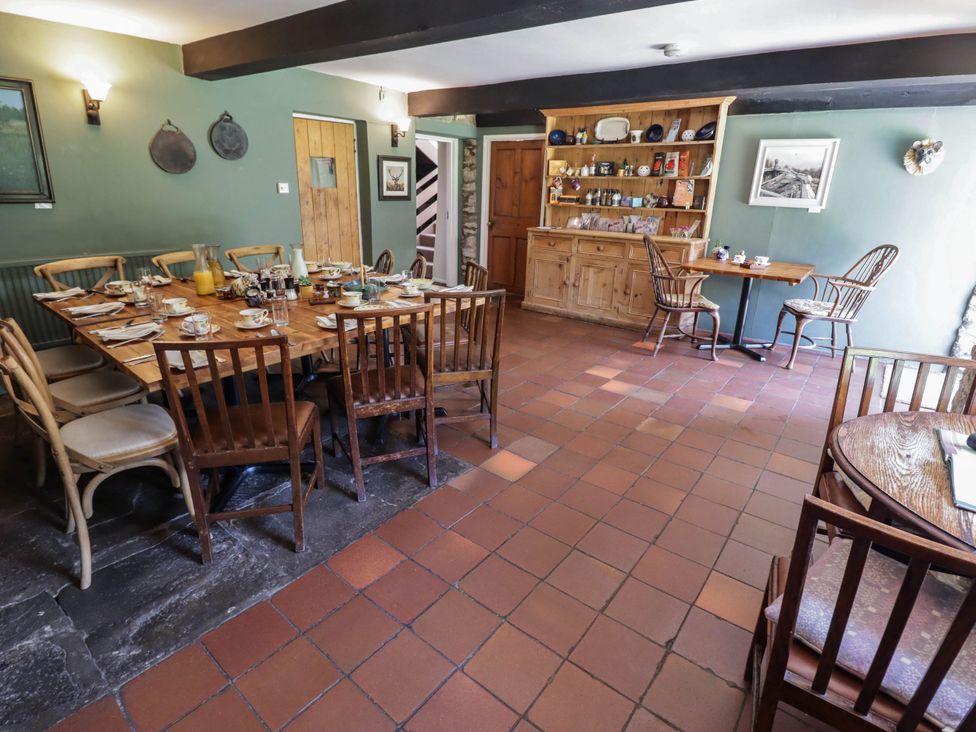 A dining room with a table set for breakfast at Ty Mawr Country House in Carmarthen