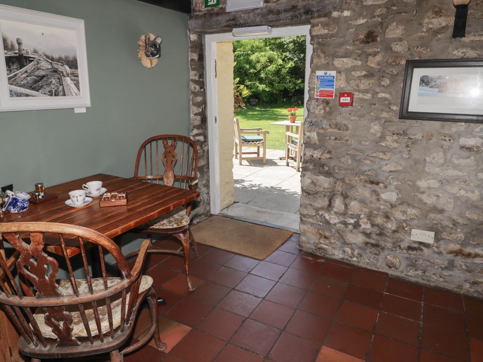 A dining room with a table and chairs at Ty Mawr Country House in Carmarthen