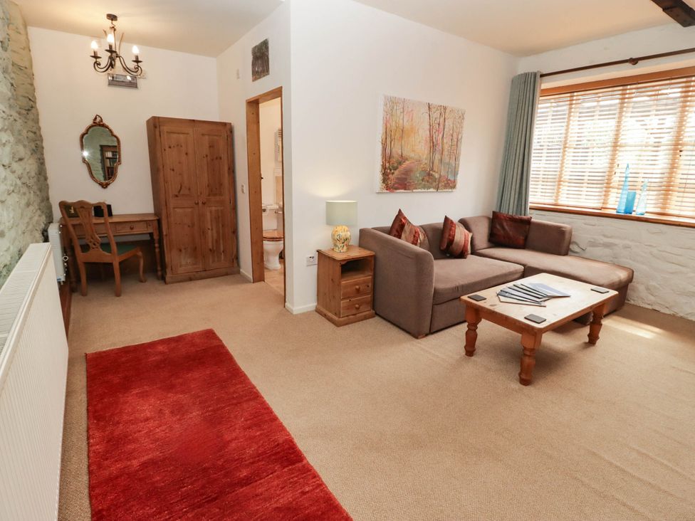 A living room with a sofa and table at Ty Mawr Country House in Carmarthen