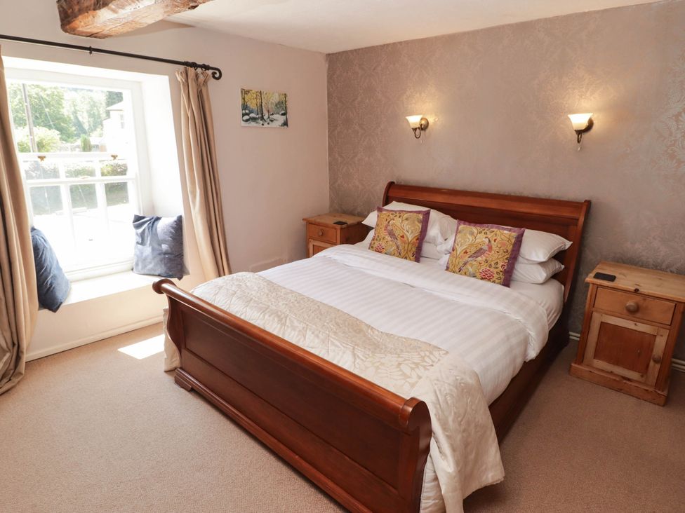 A bedroom with a bed and a window seat at Ty Mawr Country House in Carmarthen