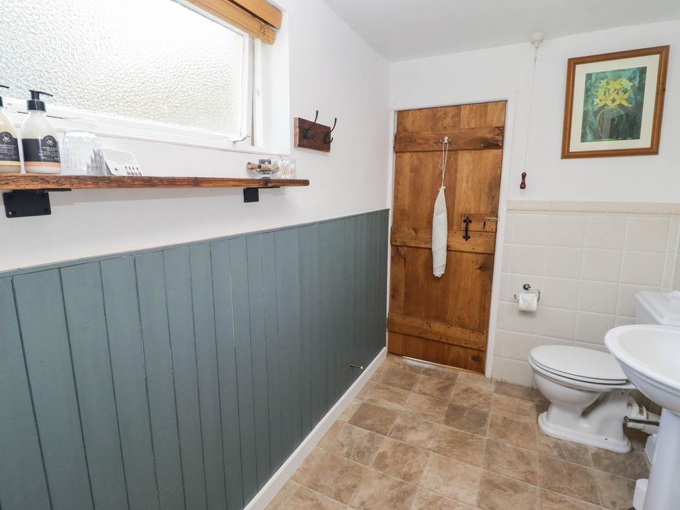 A bathroom with a toilet and sink at Ty Mawr Country House in Carmarthen
