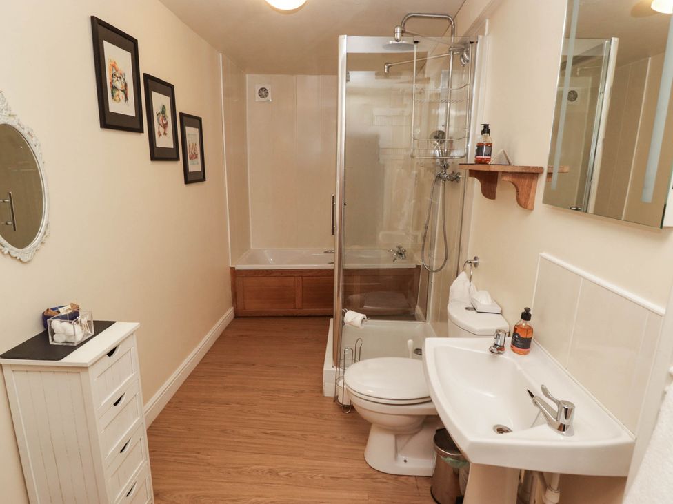 A bathroom with shower, toilet, bathtub, and sink at Ty Mawr Country House in Carmarthen