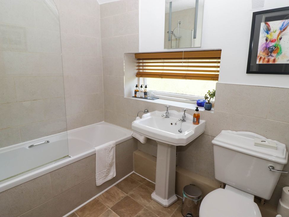 A bathroom with bathtub, sink, and toilet at Ty Mawr Country House in Carmarthen