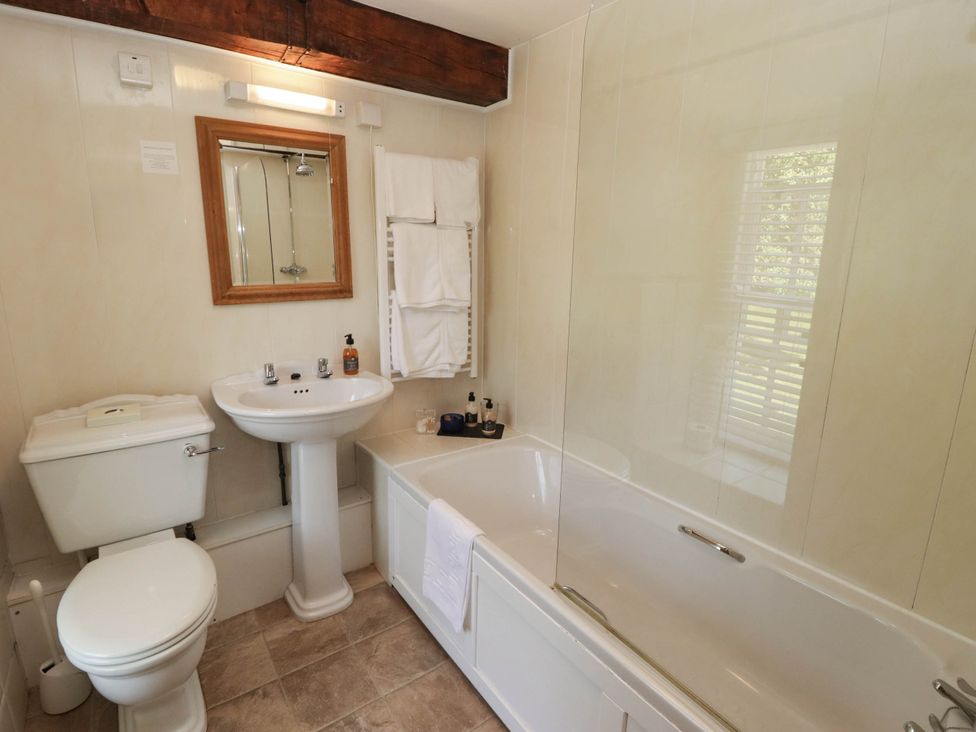 A bathroom with a bathtub, sink and toilet at Ty Mawr Country House in Carmarthen