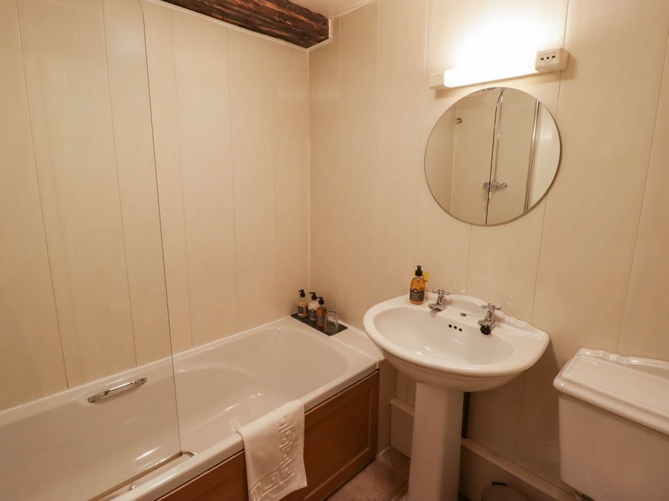 A bathroom with a bathtub, sink, and toilet at Ty Mawr Country House in Carmarthen